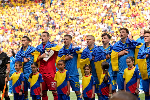 Ukrainian players sing their national anthem